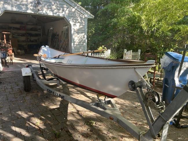 Custom wooden row boat, on trailer starboard side view