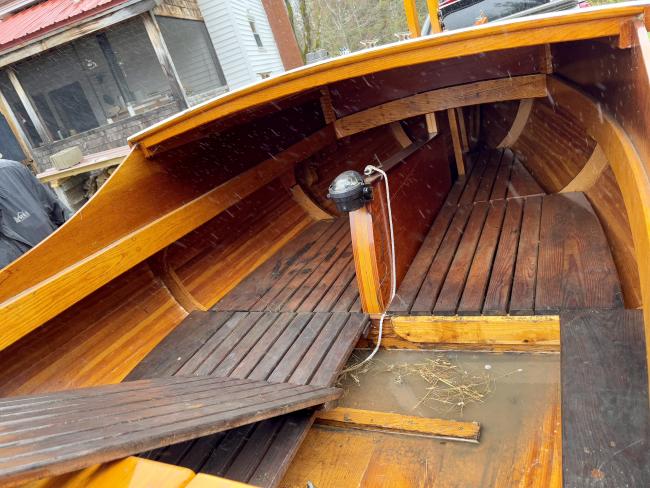 Gaff rigged wooden sailboat with trailer, up close view inside