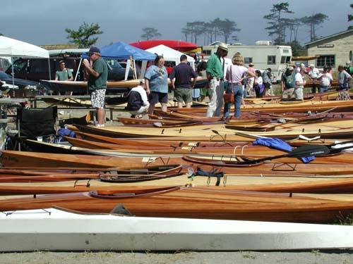 Spectators look at some of the wooden kayaks at the West Coast Wooden Kayak Rendezvous