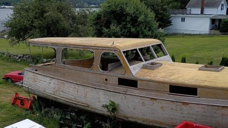 38' foot Matthews deluxe stock cruiser, on the lawn, on stands, starboard side view