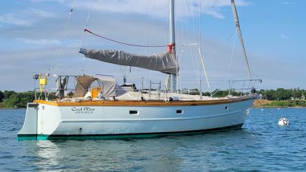 Cold-molded sloop Ceol Mor for sale, on mooring in water, starboard side stern end view