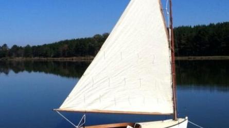 Catboat "Dell", sail up on mooring, starboard side view