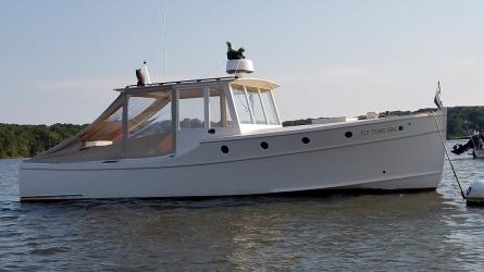 Doug  Hylan Bowler 26' 6" Power Cruiser , in water starboard side view