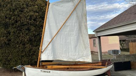Cats paw dinghy row and sail, on trailer port side view