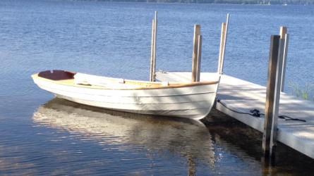 Penobscot 13 wooden sailboat, docked starboard side view