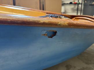 English Wooden Optimist Dinghy – Hull No. K3658, small hole on the starboard exterior
