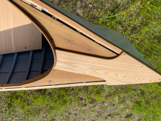 14 Foot Rushton Wooden Canoe, view above of end on grass