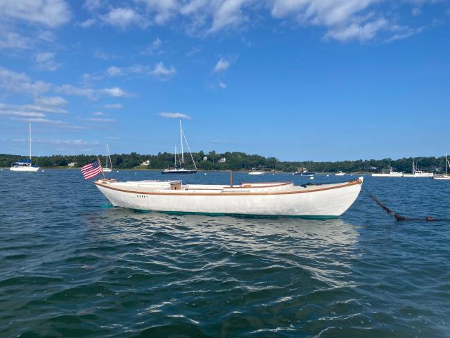 1923 Cape Cod Power Dory , in water  moored, starboard side view blue sky day