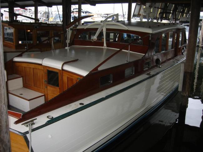 Classic wooden twin diesel cruiser, docked starboard side view