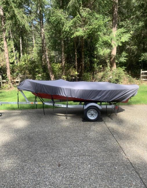 Catspaw Dinghy strip Plank Versian, on trailer covered port side view