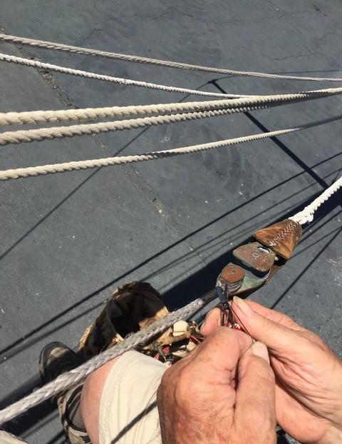 Herreshoff Original H-28 Bright Star, hands rigging up close