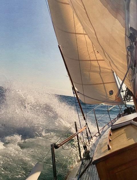 Herreshoff Original H-28 Bright Star, undersail, view of water and sail and rail on port side