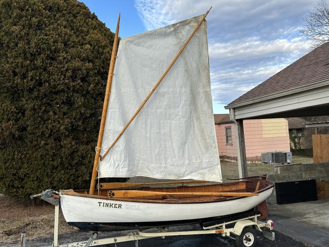 Cats paw dinghy row and sail, on trailer port side view