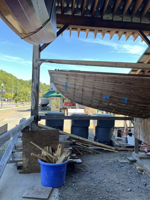 Wooden ballast keel sloop "RASCAL", on stands inside port side view, bow end