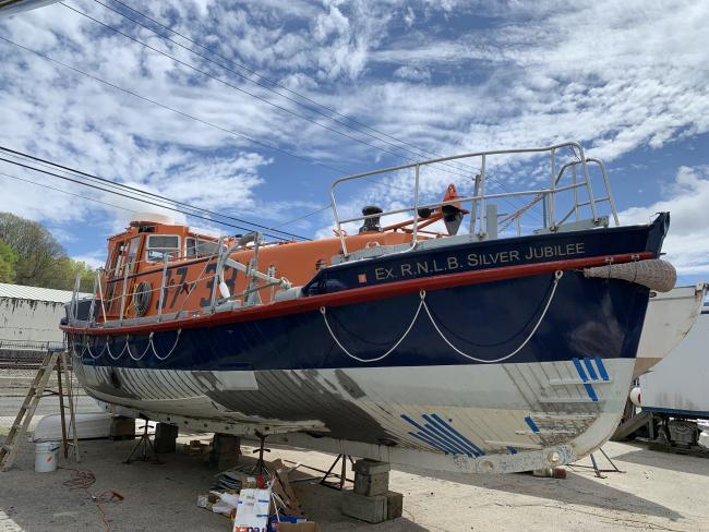 Ex-RNLI Silver Jubilee Lifeboat from UK, port side bow view on the hard