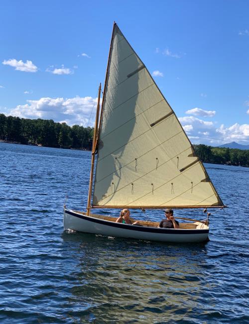 New 12' Goeller design Dinkey, in water sail up port side view