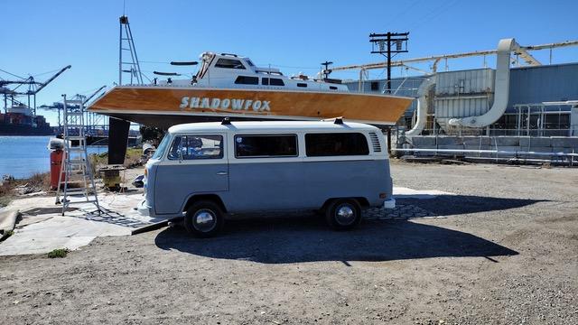 "SHADOWFOX" 31' Ocean crossing cruiser, on the hard, starboard side view and a VW bus