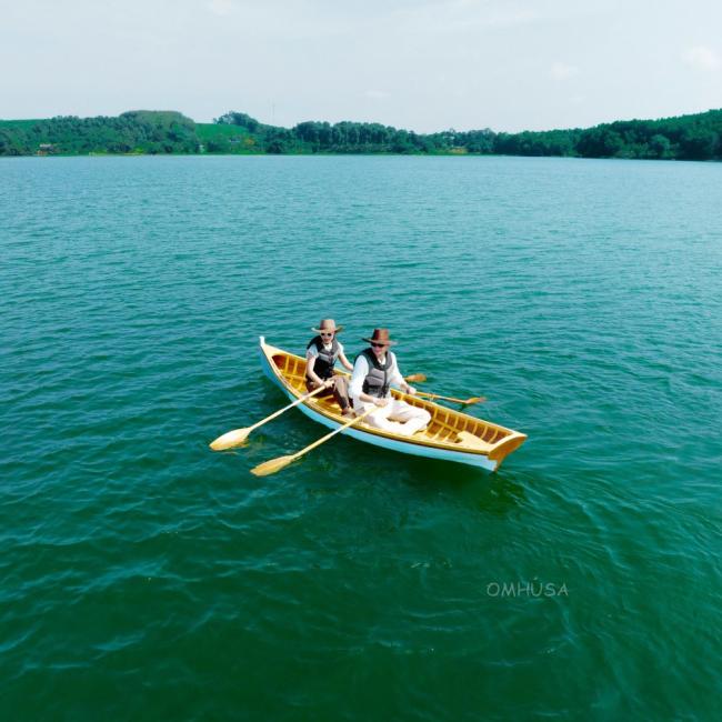 12 Ft Wooden Whitehall Rowboat with Gelcoat reinforcement, view two people rowing in water looking above