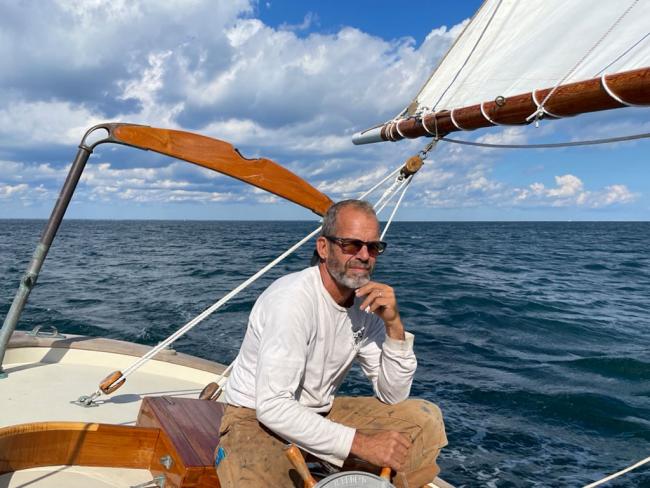 Brad Abbott sits aboard a sailboat.