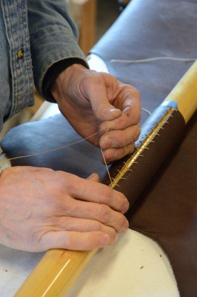 Sewing on oar leather.