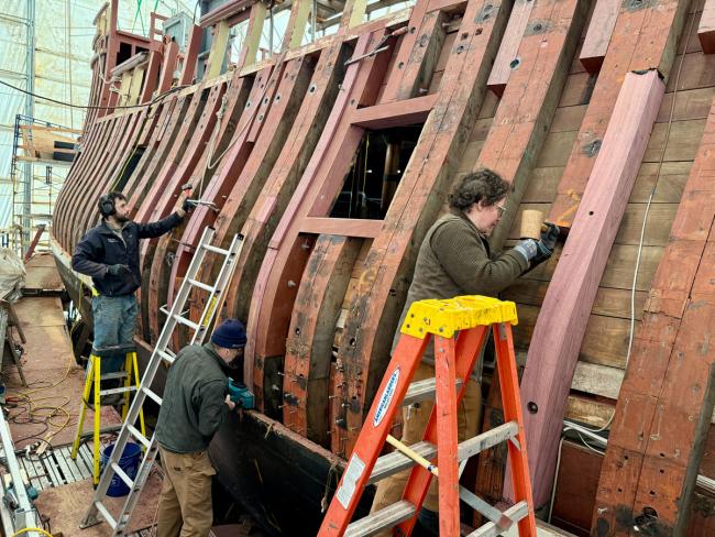 Workers repair the hull of SUSAN CONSTANT.