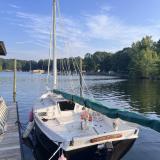 Custom Phil Bolger Wooden Triple-Keel Sloop, docked port side stern view