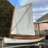 Cats paw dinghy row and sail, on trailer port side view