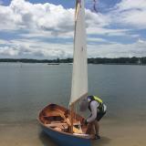 Chesapeake Light Craft Skerry, sail up, clouds, water, ready to launch