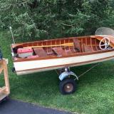 Boat built in 1958, Evinrude big twin motor, electric start, on trailer on the hard